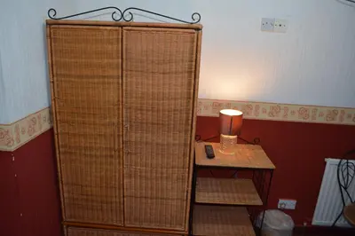 a room with a rattan door and a table with a lamp at BLACKPOOL MERCY Inn HOTEL in Blackpool