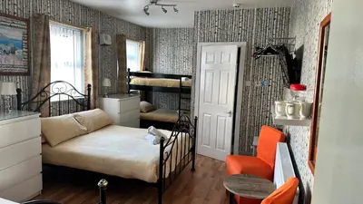 a small room with a bed and a chair at Fairhaven Hotel on Woodfield Road in Blackpool