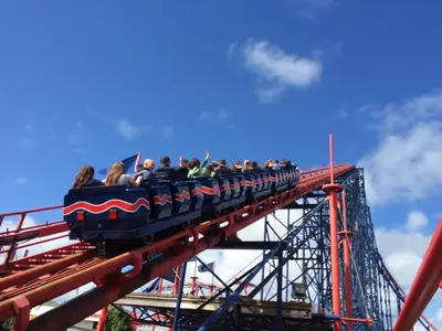 a group of people riding a train on a roller coaster at Fairhaven Hotel on Woodfield Road in Blackpool