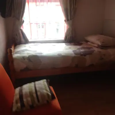 a bedroom with a bed and a window at Fairhaven Hotel on Woodfield Road in Blackpool