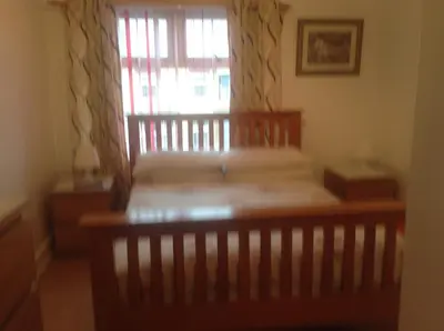 a bed in a room with a window and a crib at Fairhaven Hotel on Woodfield Road in Blackpool