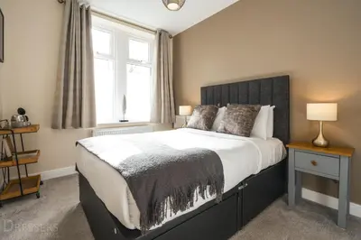 a bedroom with a large bed and a window at Rooms at The Dressers Arms in Chorley
