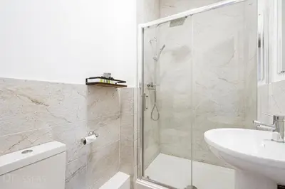 a bathroom with a shower and a toilet and a sink at Rooms at The Dressers Arms in Chorley
