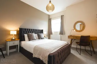 a bedroom with a bed and a desk and a mirror at Rooms at The Dressers Arms in Chorley