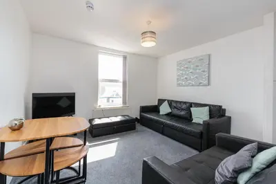 a living room with a couch and a table at Cherry Property - Apple Suite in Blackpool