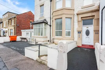 an empty parking lot in front of a house at Cherry Property - Apple Suite in Blackpool