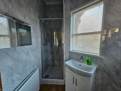 a bathroom with a shower and a sink at Collingwood Hotel in Blackpool