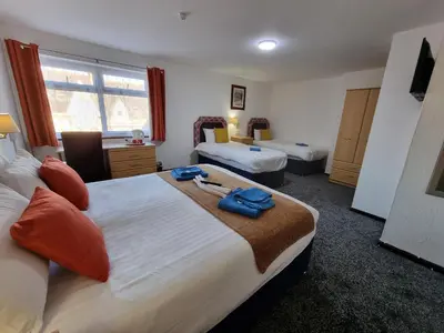 a hotel room with two beds in a room at Collingwood Hotel in Blackpool