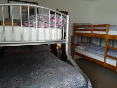a room with two bunk beds and a bed in it at Delamere Hotel in Blackpool