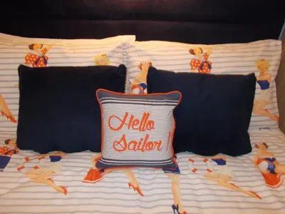 a bed with a pillow with people on it at Delamere Hotel in Blackpool