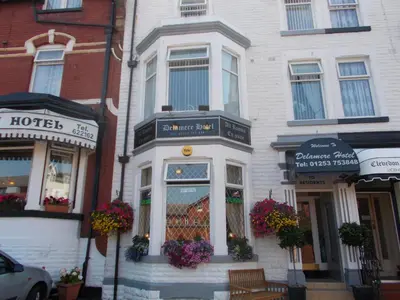a white building with flowers in the front of it at Delamere Hotel in Blackpool