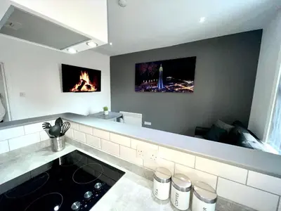 a kitchen with a stove and a fire in it at Reads Jacuzzi Apartments in Blackpool