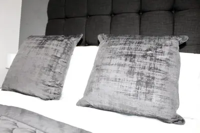 a bedroom with a bed with two pillows on it at Reads Jacuzzi Apartments in Blackpool