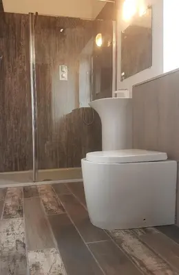 a bathroom with a white toilet and a shower at Loftnine9 in Liverpool