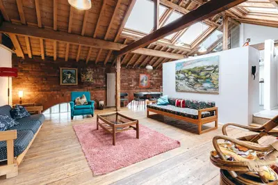 a living room with two couches and a rug at Loftnine9 in Liverpool