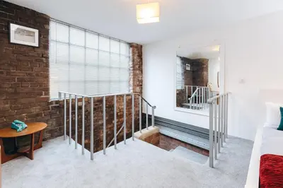a room with a staircase and a brick wall at Loftnine9 in Liverpool