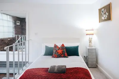 a bedroom with a bed with a red blanket at Loftnine9 in Liverpool