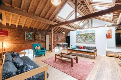 a living room with two couches and a table at Loftnine9 in Liverpool