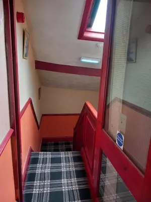 a staircase in a room with a red door at My Adam Hotel in Blackpool