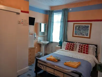 a bedroom with a bed with two towels on it at My Adam Hotel in Blackpool