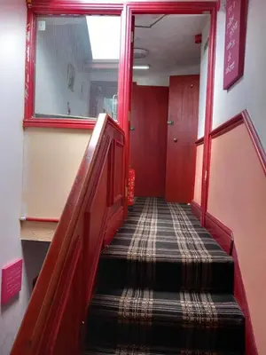 a flight of stairs in a room with red walls at My Adam Hotel in Blackpool