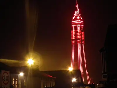 a red and white tower lit up at night at My Adam Hotel in Blackpool