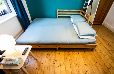 a bed in a room with a table and a bed sidx sidx sidx at Peaceful House in the Centre of City in Lancaster