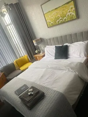 a hotel room with a bed with a book on it at Bradburys of Blackpool in Blackpool