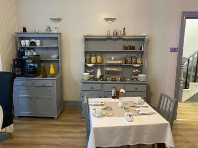 a kitchen with a table and a counter with a stove at Bradburys of Blackpool in Blackpool
