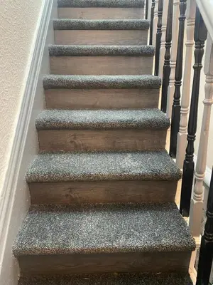 a set of stairs with grey carpeting and wood at Bradburys of Blackpool in Blackpool