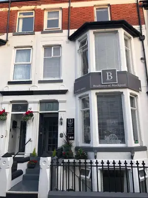 a white building with a sign on the front of it at Bradburys of Blackpool in Blackpool