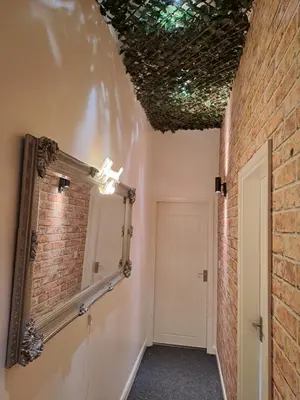 a room with a mirror and a brick wall at Harrington Suite in Liverpool
