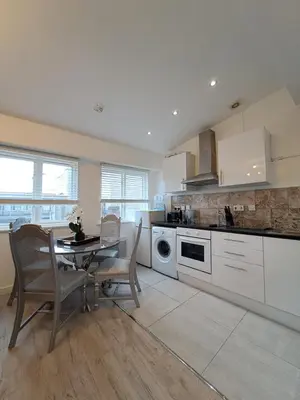 a kitchen with a table and a dining room at Harrington Suite in Liverpool