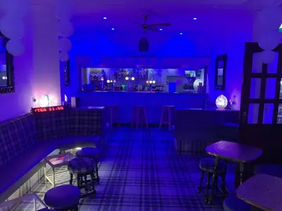 a bar with purple lights in a room at Granville Hotel in Blackpool