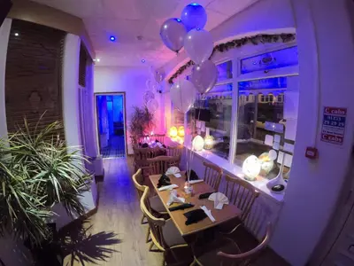 a room with a table and balloons in a restaurant at Granville Hotel in Blackpool