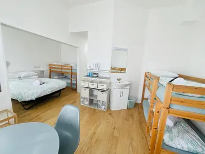 a dorm room with two bunk beds and a ladder at Granville Hotel in Blackpool