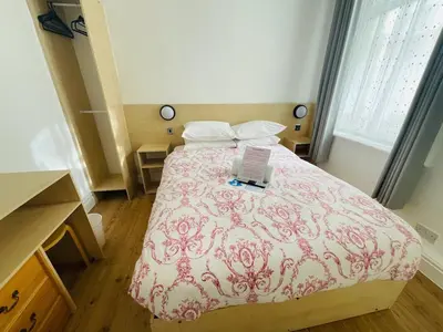 a bedroom with a bed with a laptop on it at Granville Hotel in Blackpool