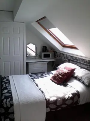 a bedroom with a bed with two pillows on it at The Breverton in Lytham St Annes