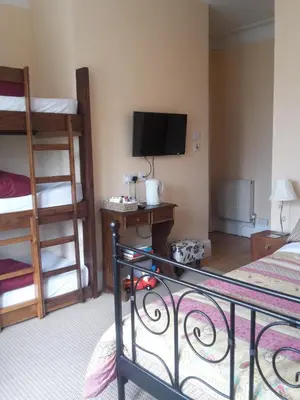 a hotel room with a bed and a television and a bed gmaxwell gmaxwell gmaxwell gmaxwell at The Breverton in Lytham St Annes