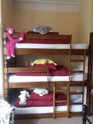 a bunk bed with three bunk beds with stuffed animals at The Breverton in Lytham St Annes