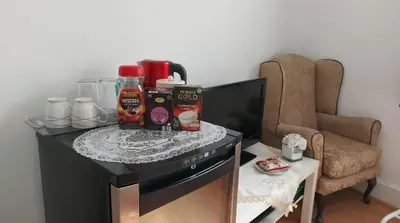 a table with food and drinks on top of a tv at Spacious Double Room in Anfield in Liverpool