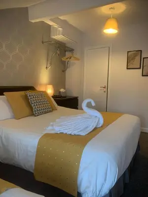 a bedroom with a bed with a swan on it at The Strathdon in Blackpool