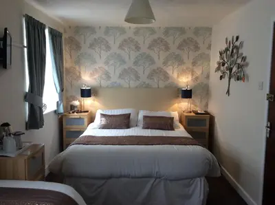a bedroom with a bed with two night stands and two lamps at The Strathdon in Blackpool