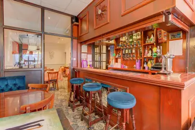 a bar with blue stools in a restaurant at The Strathdon in Blackpool