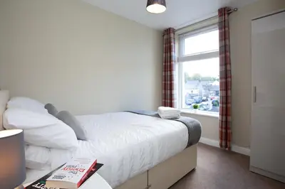 a small bedroom with a bed and a window at Spacious 3 bedroom Cottage in Whalley in Whalley