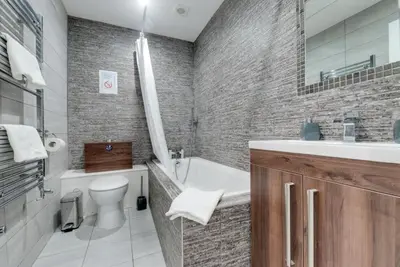 a bathroom with a tub and a sink and a toilet at RST Rodney Street in Liverpool