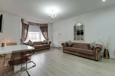 a living room with two couches and a table at RST Rodney Street in Liverpool