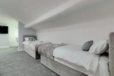 two beds in a room with white walls at RST Rodney Street in Liverpool
