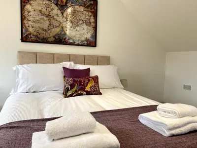 a bedroom with a bed with two towels on it at Princess Theatre Beach View Apartments by Blackpool Service Apartments in Blackpool