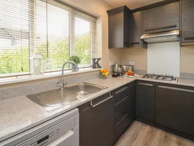 a kitchen with a sink and a window at Kilmory Lodge in Poulton le Fylde